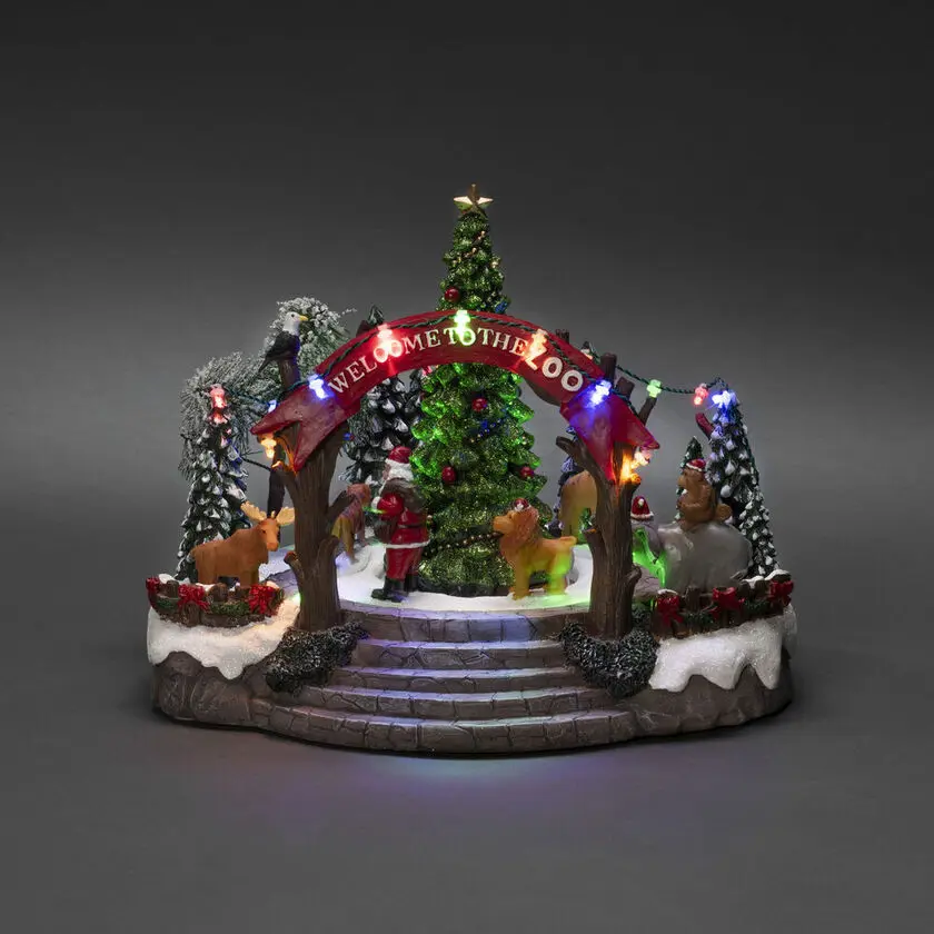 Mekanisk Juledekoration Med Zoologisk Have 20cm Flerfarvet Fra Konstsmide - Denne mekaniske juledekoration byder p&aring; en farverig scene med 19 varmhvide LED-lys, musik, dyr og julemanden omkring et funklende juletr&aelig;.