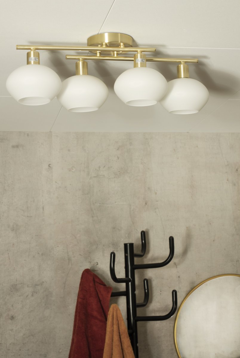 Elba 60cm Mat messing badeværelseslampe Fra Aneta Lighting - Denne lampe er lavet af metal og har et elegant design med fire opalhvide glaskupler, der giver et bl&oslash;dt og behageligt lys.