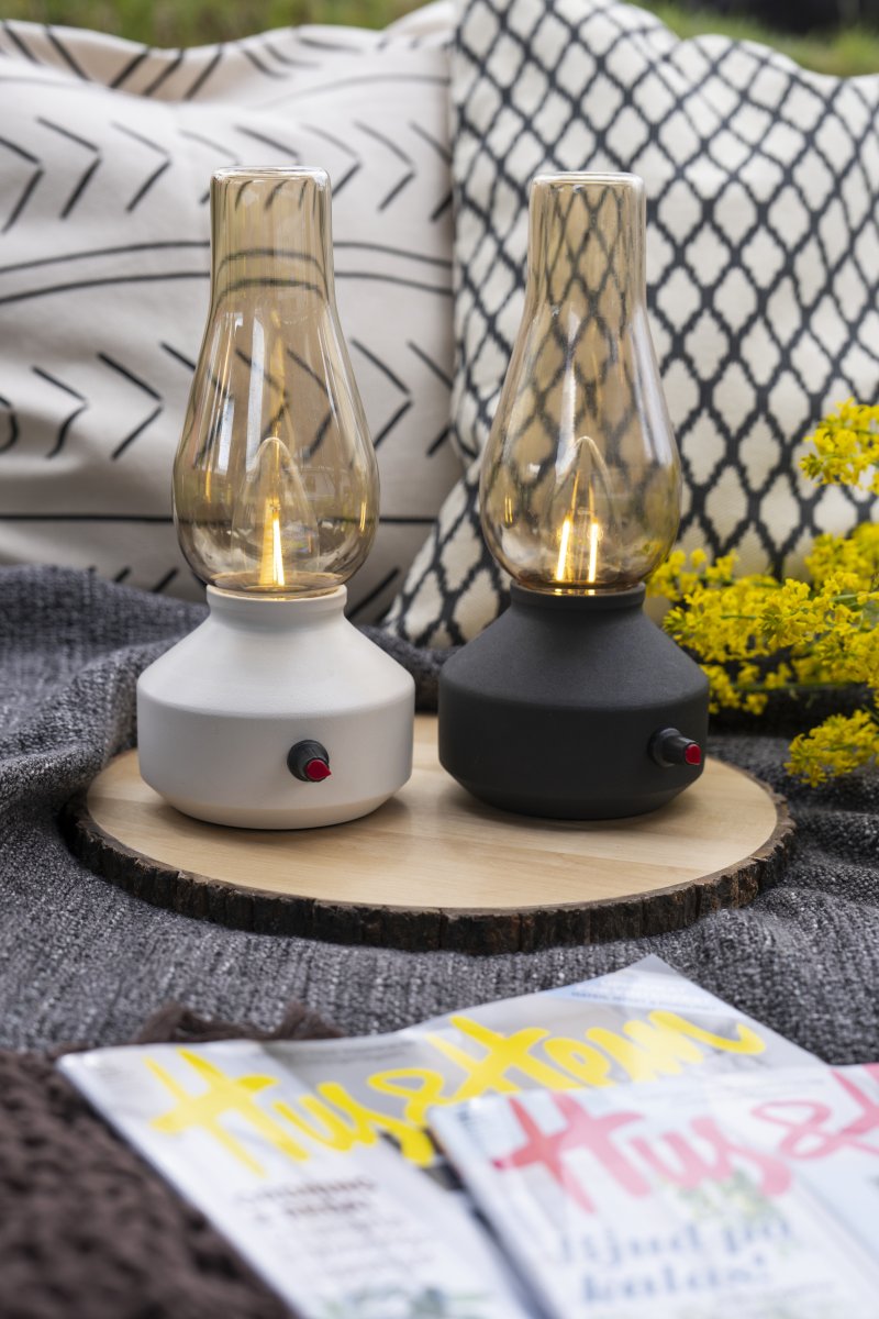 Genopladelig bordlampe 25cm Sort bærbar Fra Konstsmide - Lampen er lavet af metal og glas med en sort lampebase og en praktisk lysdæmper, der gør det nemt at justere det varme hvide, atmosfæriske lys.