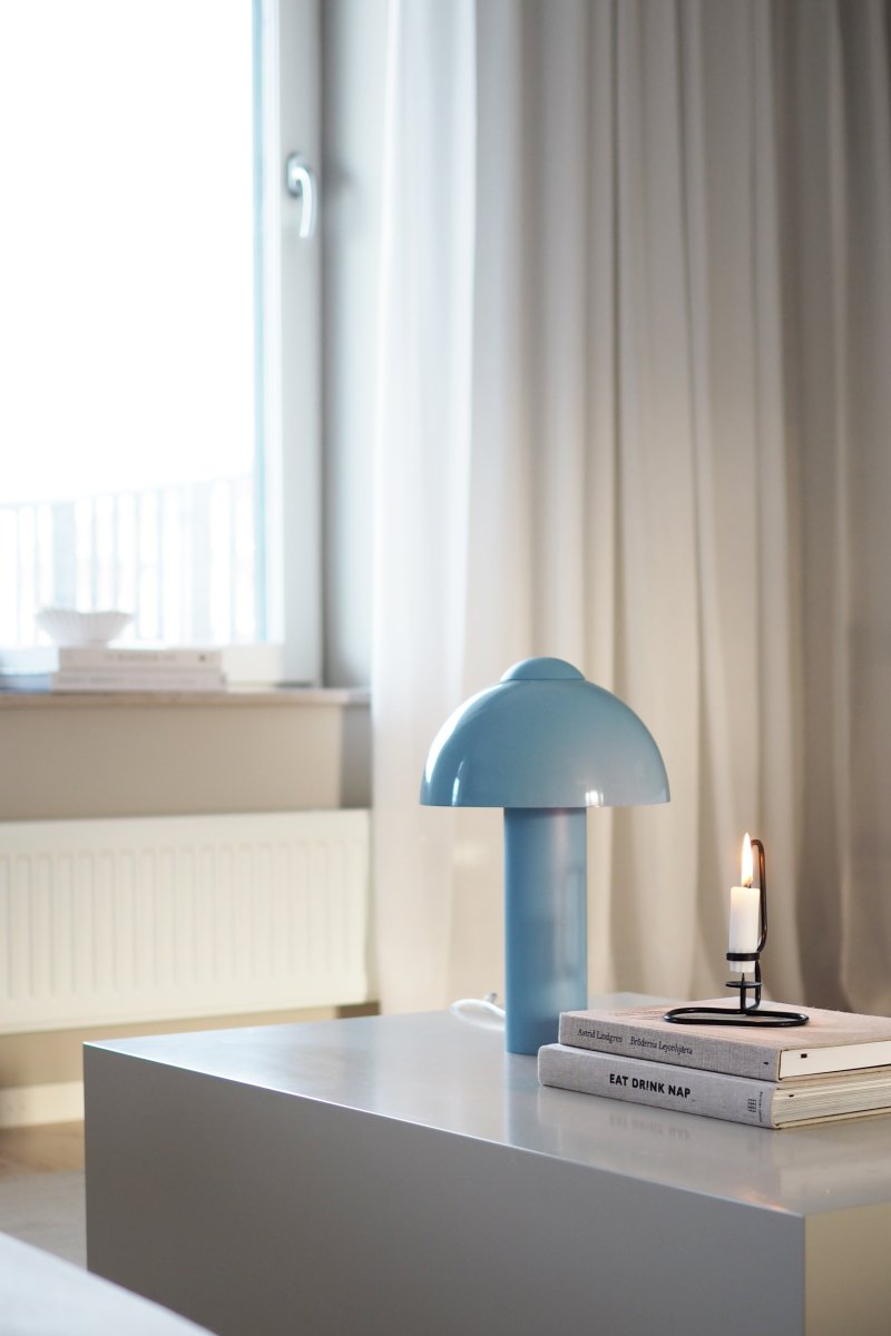 Buddy 36cm Lyseblå bordlampe Fra Globen Lighting - Den matte lampebase og -top står i kontrast til en højglansskærm.