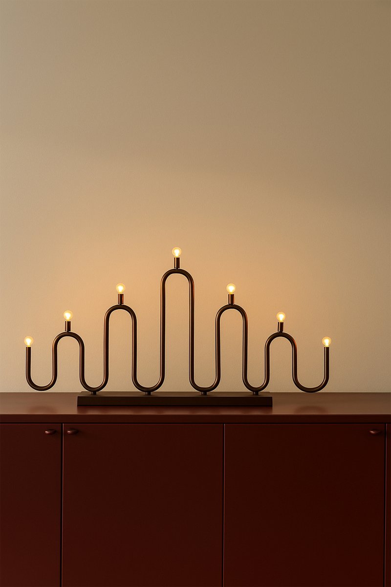 Noel 7 Bronze Fra Globen Lighting - Det bl&oslash;de, b&oslash;lgede design er skabt af metalr&oslash;r, der er b&oslash;jet i h&aring;nden p&aring; forskellige niveauer, og giver en moderne fortolkning af den klassiske adventslysholder.
