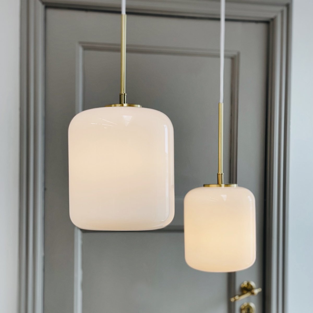 Silvia Ø20 Messing loftslampe Fra Dyberg Larsen - Silvia er en serie af loftslamper lavet af mundblæst opalglas med en blank overflade, messingsokkel og hvid tekstilledning.