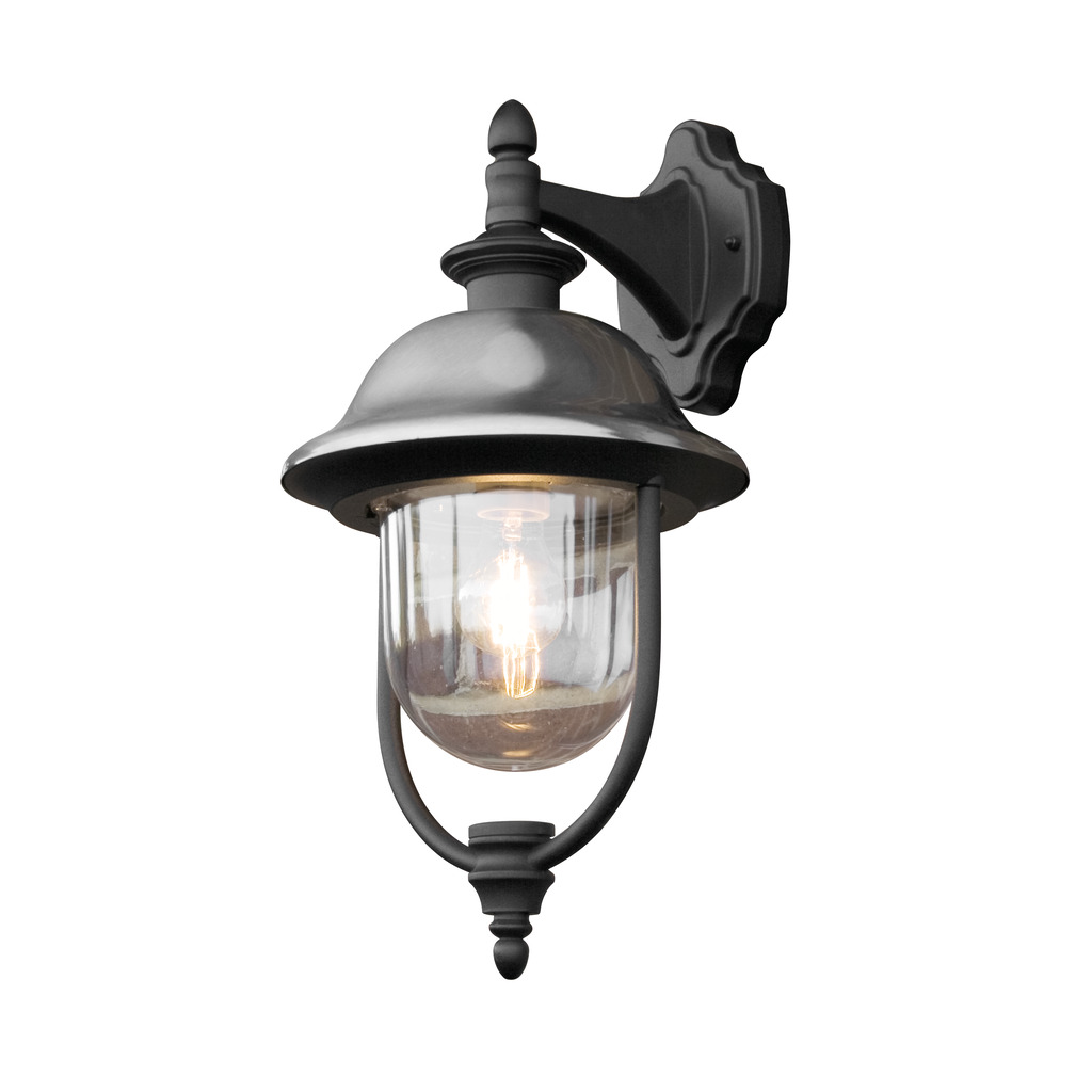 Parma Sort udendørslampe Fra Konstsmide - Med sin robuste sorte finish og klare glaskuppel spreder den et varmt og indbydende skær og skaber en indbydende atmosfære ved indgangen eller terrassen.