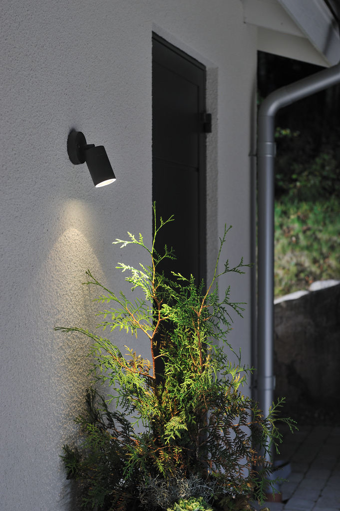 Modena Sort udendørslampe Fra Konstsmide - Lampen er retningsbestemt, hvilket giver et praktisk og effektivt lys, der skaber tryghed og elegance i udemiljøet.