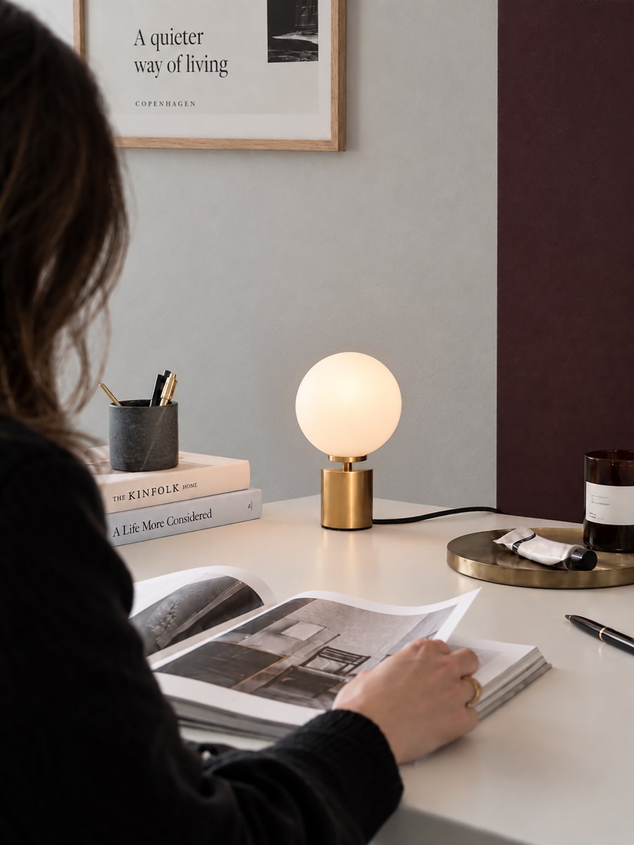 Ballon 24cm Messing bordlampe Fra Herstal - Ballon er en elegant bordlampe med et stilfuldt og tidløst design, der kombinerer metal i en smuk satineret messingfinish med en rund skærm af opalglas.