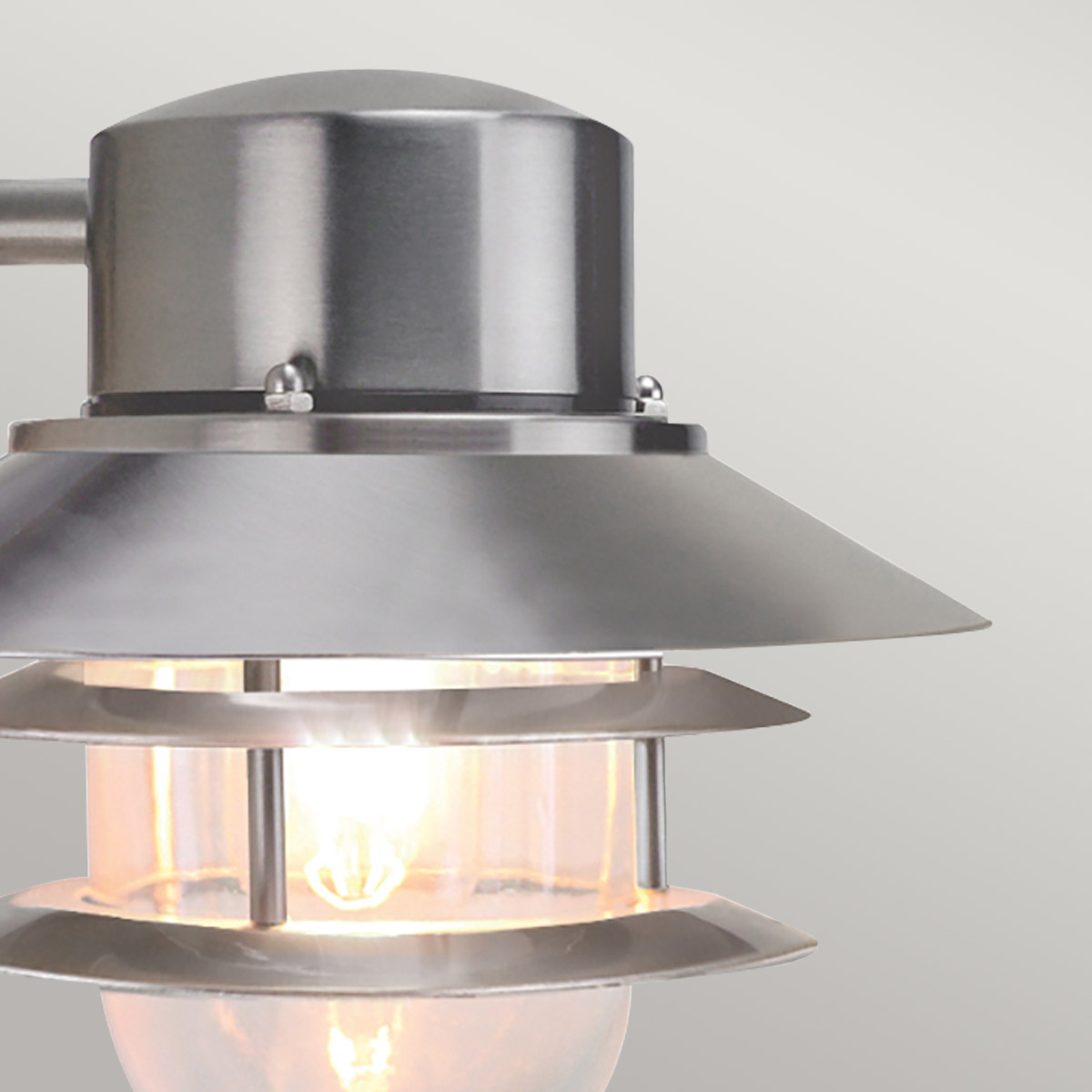 Copenhagen Ø22 Børstet stål udendørslampe Fra Elstead Lighting - Tillverkad av rostfritt st&aring;l i borstad finish och glas, erbjuder den en h&aring;llbar och v&auml;dert&aring;lig konstruktion som passar perfekt f&ouml;r fasader, entr&eacute;er och uteplatser.