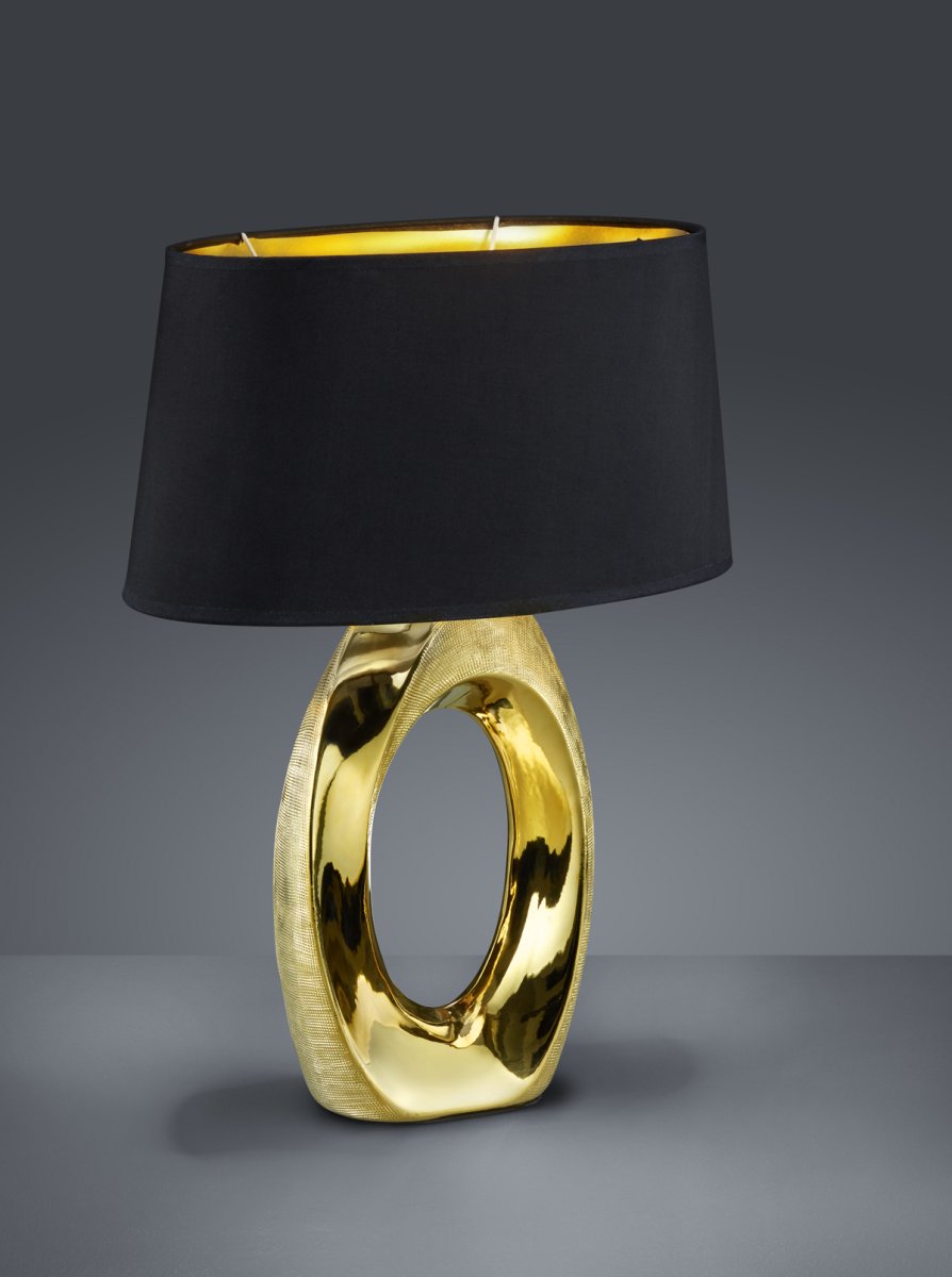 Taba 52cm Guld bordlampe Fra Trio Lighting - Med sine mål på 38x52 cm giver den den rette lysstemning og er dekorativ som sengelampe, på en byr&aring; eller et sidebord.